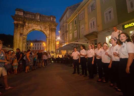Silver tour performing in front of Arch of the Sergii, Pula, Croatia