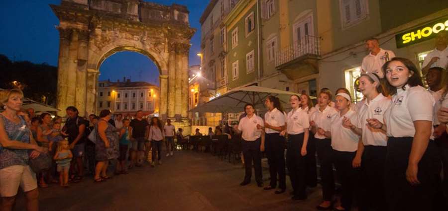 Silver tour performing in front of Arch of the Sergii, Pula, Croatia