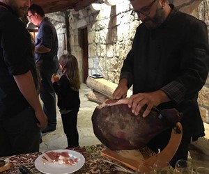Niko slicing locally cured ham called prsut