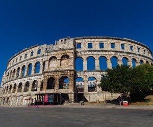 Silver tour visiting Roman amphitheater in Pula, Croatia